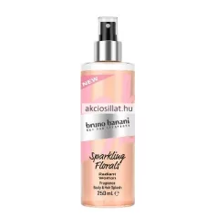 Bruno Banani Radiant Woman 250ml-es női testpermet és hajpermet hengeres, átlátszó flakonja ezüst porlasztófejjel, barackszínű folyadékkal és rózsaszín mintás felirattal.