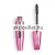 A Revolution Wispy Lash Feather Effect Mascara Szempillaspirál 8g.jpg képen a fémesen csillogó, rózsaszín tubusú szempillaspirál látható kitekert állapotban, mellette a sűrű, fekete sörtefejjel ellátott keféjéve