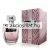 Chatler Who is New Woman 100ml-es női parfüm áttetsző íves üvegben rózsaszín színű parfümmel fekete alapon ezüst betűs logóval és szögletes átlátszó kupakkal valamint mellette egy hozzá tartozó ezüst és rózsaszín pöttyös mintájú díszdoboz